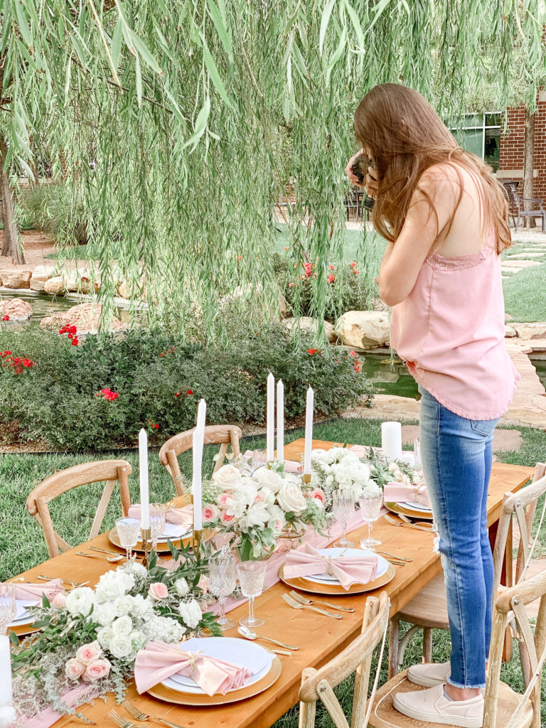 a photo of me (Melissa Grissom) photographing a table of the styled shoot I created