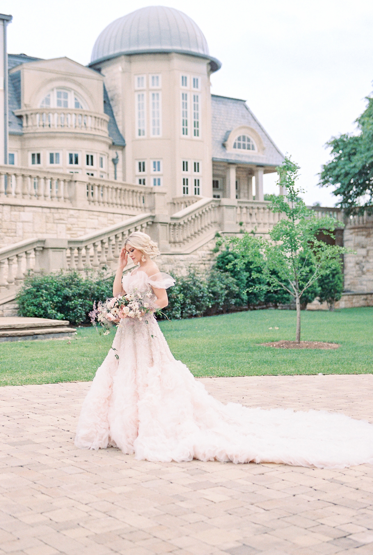 A bride being photographed behind the Olana in Hickory Creek TX