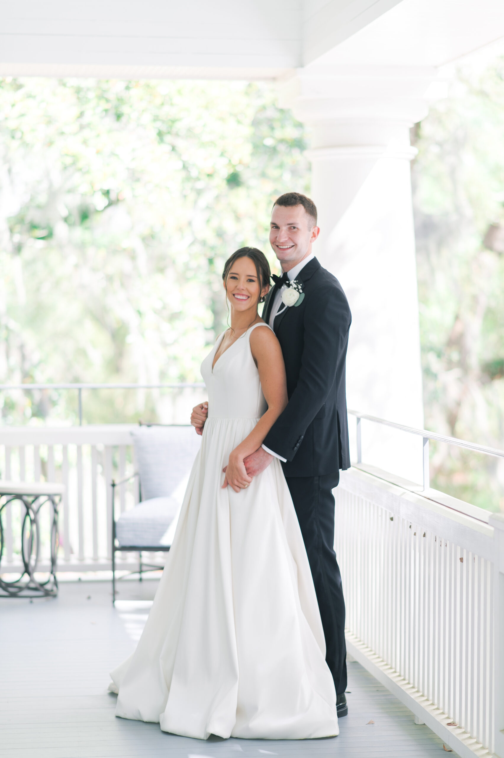 wedding couple on the porch of the admiral house in charleston