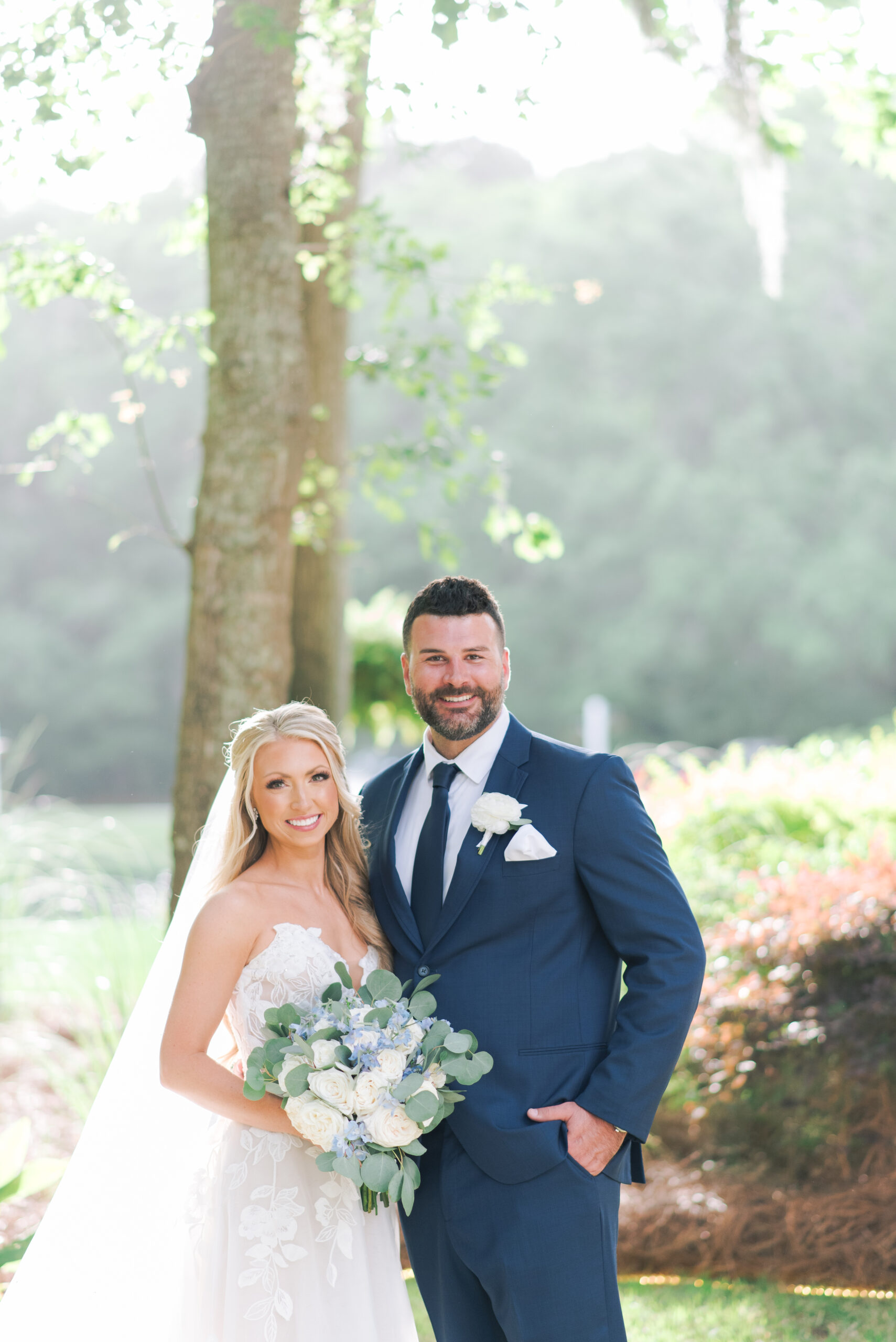 bride and groom standing on property at the mackey house savannah for their wedding