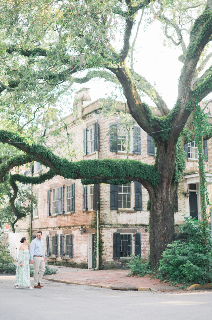 jones street, couple walking the street in downtown savannah georgia for their engagement photos