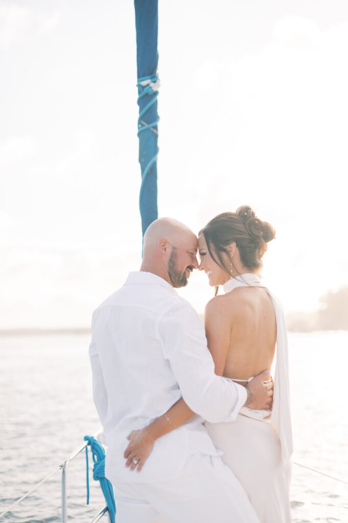 couple on sailboat for their engagement portraits in savannah georgia