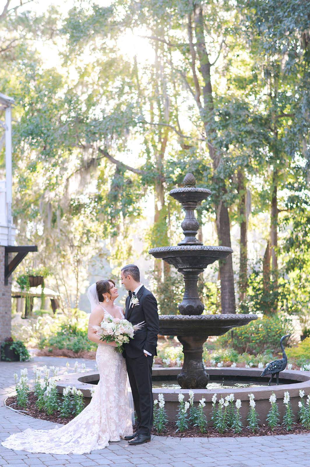 couple in front of the fountain for their wedding at the mackey house in savannah ga